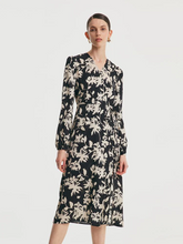 a lady in black midi silk dress